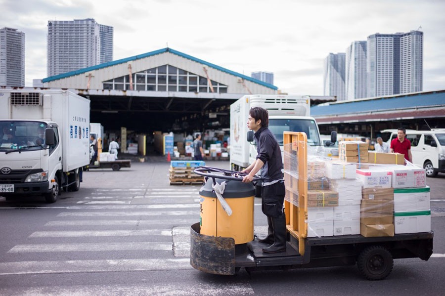 Tokyo, Japan - May 7 2017: The worker at Tsukiji fish market transporting the fresh seafood and tuna to different locations.